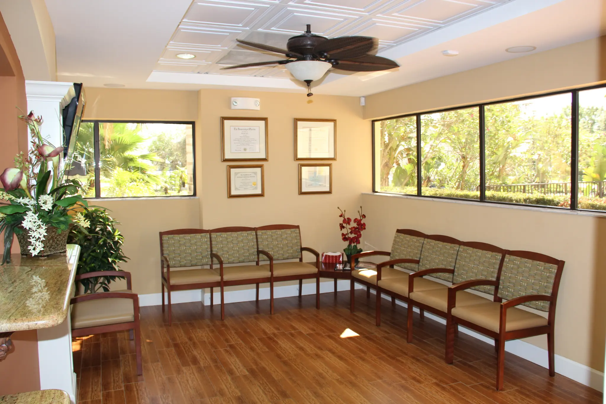 Relaxing, sunlit reception area with comfortable seating at Palm City Dentistry